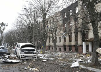 Damaged cars and a destroyed accommodation building are seen near a checkpoint in Brovary, outside Kyiv, Ukraine, Tuesday, March 1, 2022. Russian shelling pounded civilian targets in Ukraine's second-largest city Tuesday and a 40-mile convoy of tanks and other vehicles threatened the capital — tactics Ukraine's embattled president said were designed to force him into concessions in Europe's largest ground war in generations. (AP Photo/Efrem Lukatsky)