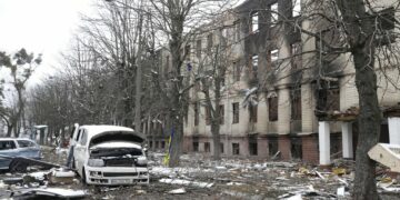 Damaged cars and a destroyed accommodation building are seen near a checkpoint in Brovary, outside Kyiv, Ukraine, Tuesday, March 1, 2022. Russian shelling pounded civilian targets in Ukraine's second-largest city Tuesday and a 40-mile convoy of tanks and other vehicles threatened the capital — tactics Ukraine's embattled president said were designed to force him into concessions in Europe's largest ground war in generations. (AP Photo/Efrem Lukatsky)